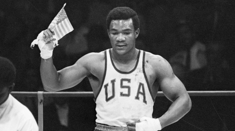 George Foreman at 1968 Olympics waving an American Flag
