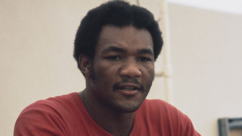 A young George Foreman wearing a red t-shirt