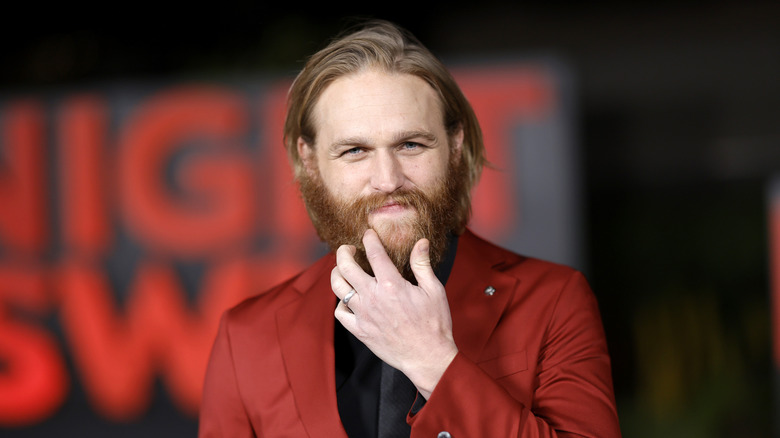 Wyatt Russell touching his beard