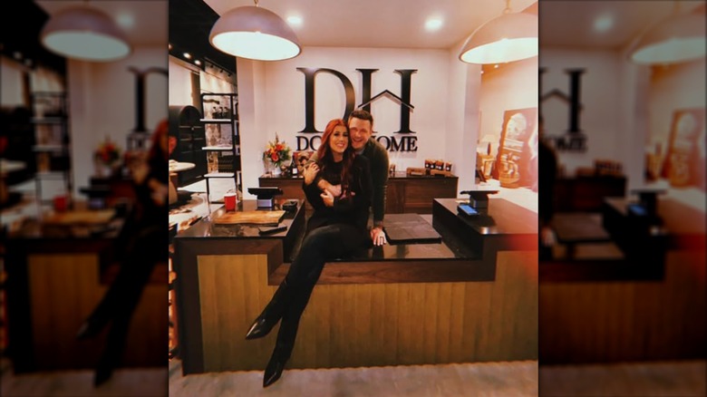Cole and Chelsea DeBoer pose together in their store