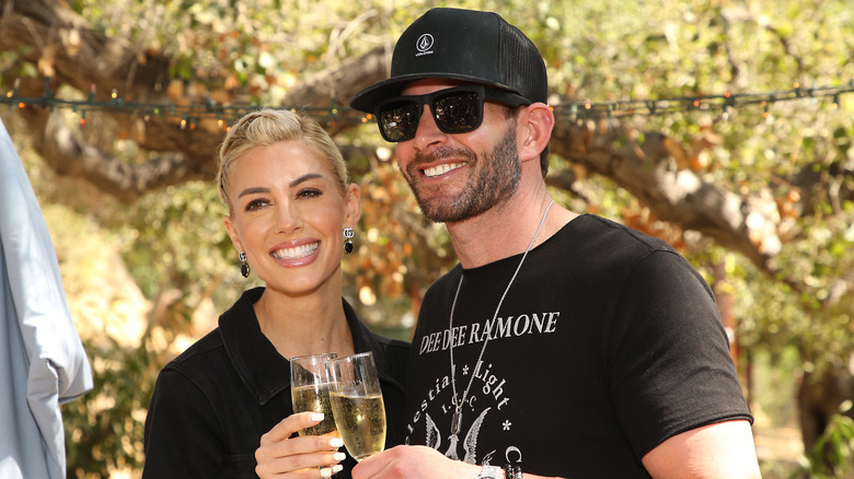 Heather Rae Young and Tarek El Moussa toast with champagne in 2021