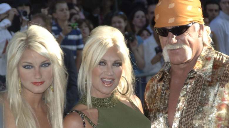 Brooke Hogan, Linda Hogan, and Hulk Hogan pose for a photo on a red carpet