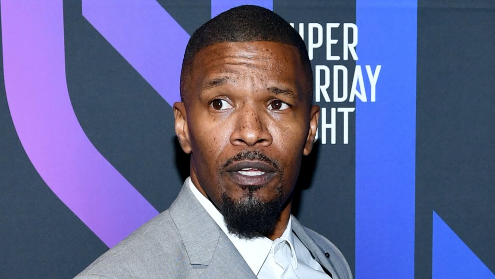 Jamie Foxx walks a red carpet in Miami in 2020