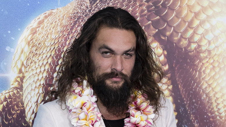 Jason Momoa, wearing a Hawaiian lei, 2018 photo 