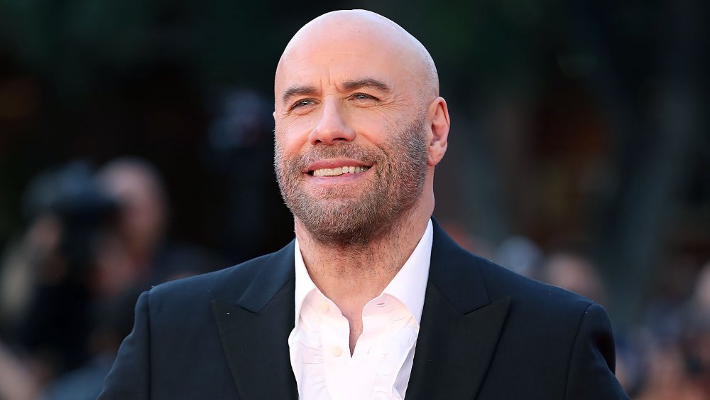 John Travolta, bald, smiling