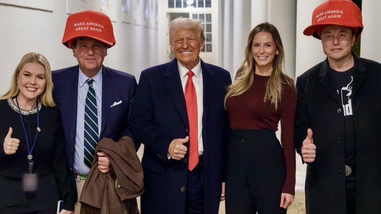 Karoline Leavitt with Donald Trump, Hope Hicks and Tucker Carlson and Elon Musk wearing giant MAGA hats