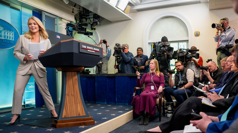 Karoline Leavitt leaving press podium after a media briefing
