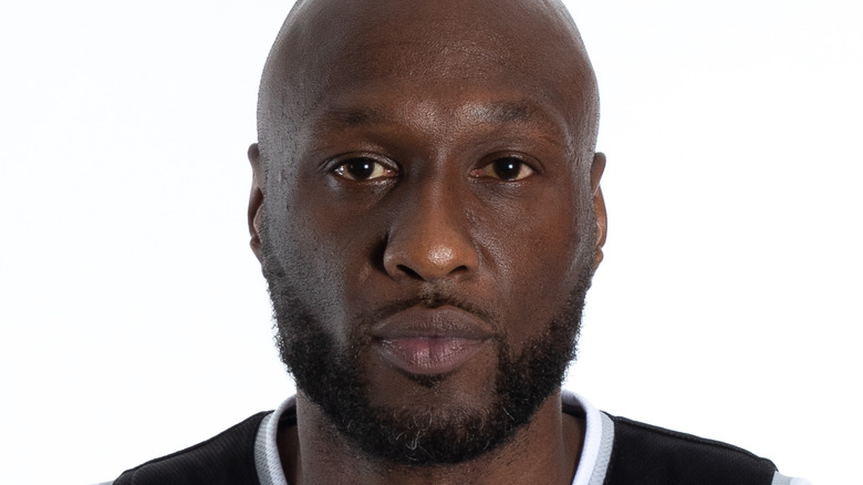 Lamar Odom wearing a black basketball jersey 