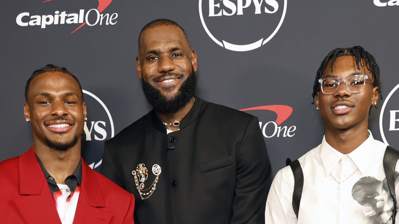 Bryce James poses with LeBron and Bronny James