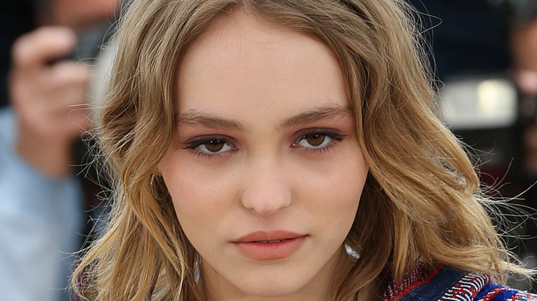 Lily-Rose Depp looks on