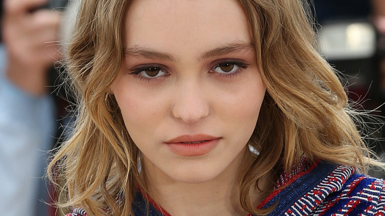 Lily-Rose Depp looks on