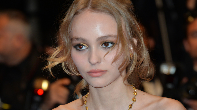 Lily-Rose Depp looks on