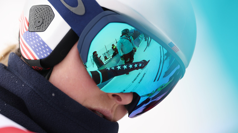 Lindsey Vonn wearing a USA ski helmet and goggles.