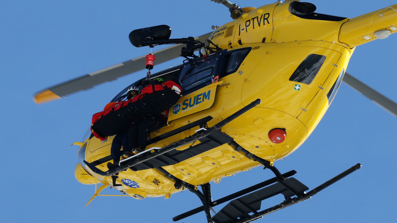 Lindsey Vonn being lifted into a helicopter and medevaced.