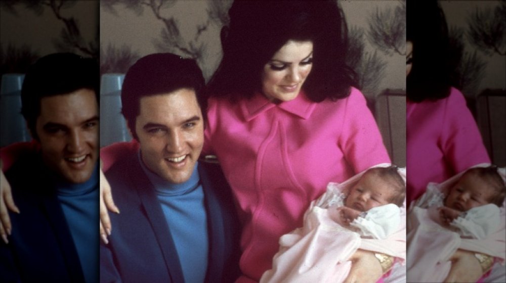 Elvis and Priscilla Presley holding Lisa Marie as a baby 