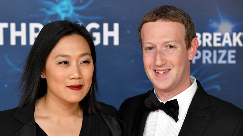 Priscilla Chan and Mark Zuckerberg pose in formal attire