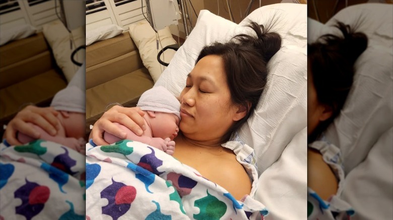 Priscilla Chan holds her third daughter Aurelia in the hospital