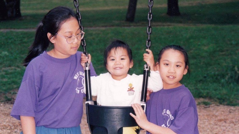 Young Priscilla Chan and her sister pose at a park