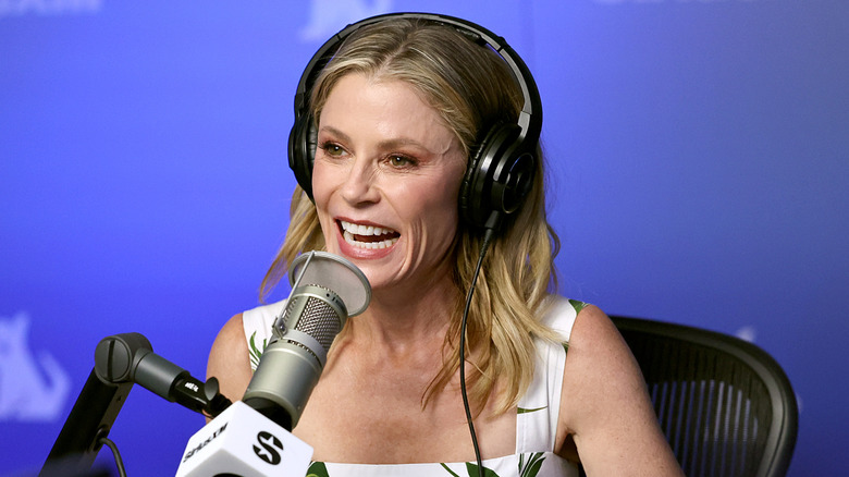 Julie Bowen laughing into a microphone
