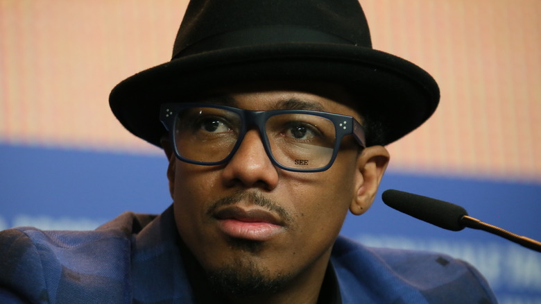 Nick Cannon wearing blue glasses