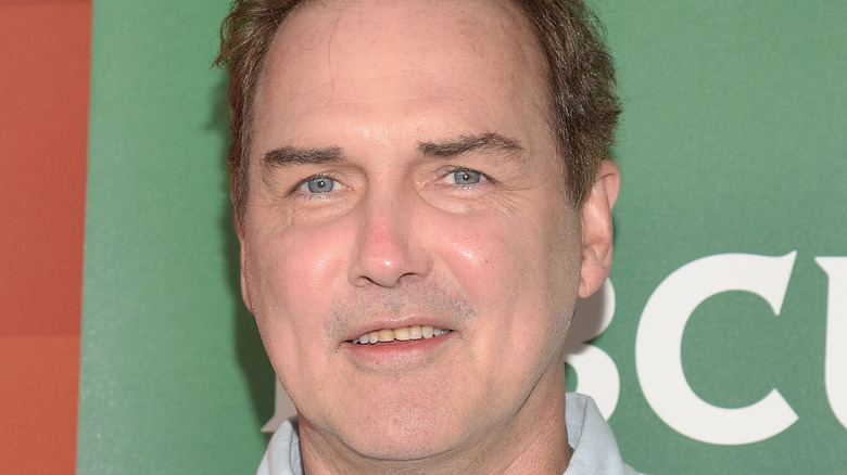 Norm Macdonald posing with a small smile