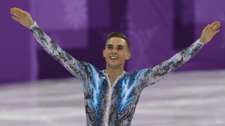 Adam Rippon skating on the ice and smiling at Team Event Men Single Skating Free Skating at the 2018 Winter Olympics