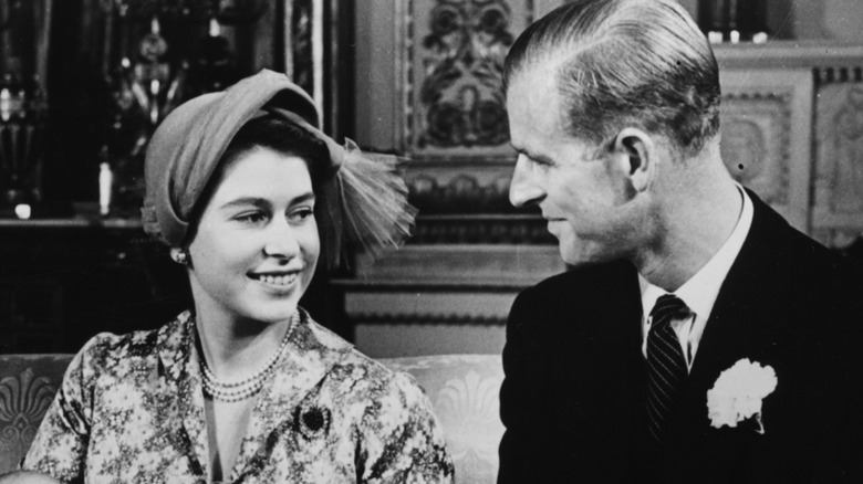 Prince Philip and Queen Elizabeth II smiling at each other