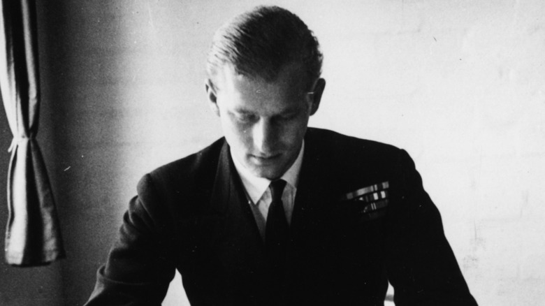 A young Prince Philip with his head down