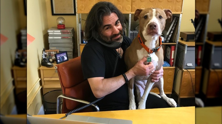 John Cusimano posing with his late dog, Isaboo.