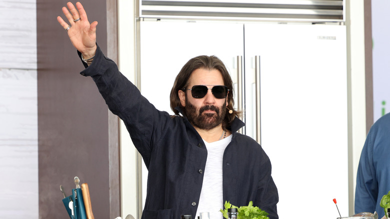 John Cusimano waves on stage at a food festival.