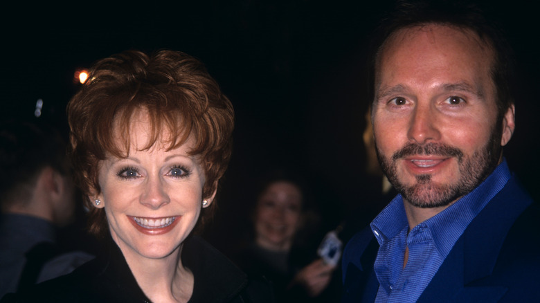 Reba McEntire and Narvel Blackstock smiling at camera
