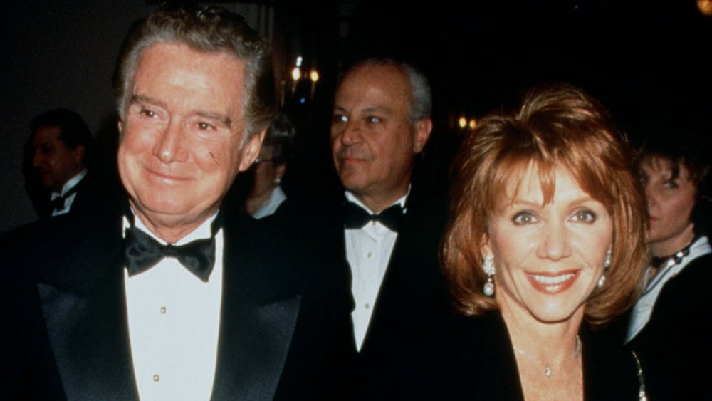 Regis Philbin and Joy Philbin in black, smiling at a black-tie event