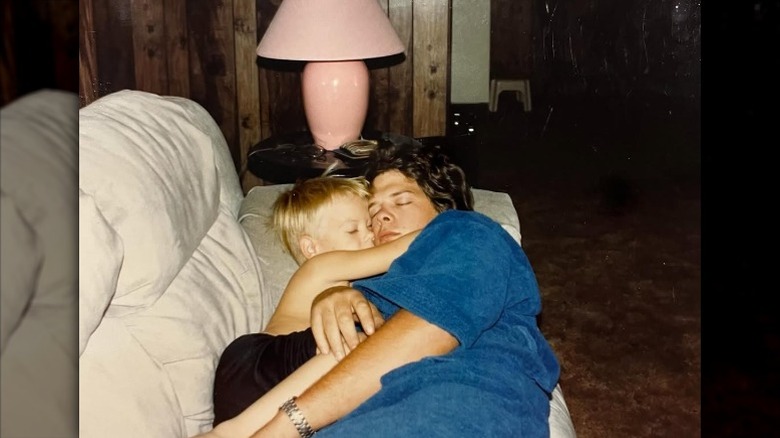 Rick Harrison hugs a young Adam on the couch