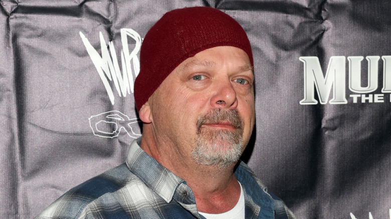 Rick Harrison poses in red beanie in 2023