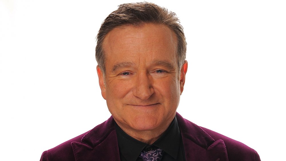 Robin Williams looking straight ahead with a soft smile