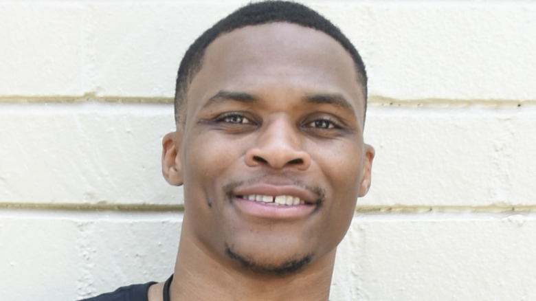 Russell Westbrook posing against a wall
