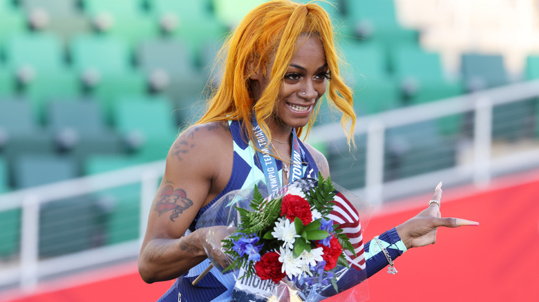 Sha'Carri Richardson holding flowers