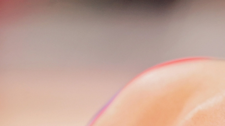 Simone Biles, looking down