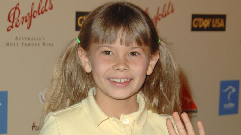 Young Bindi Irwin smiling and waving