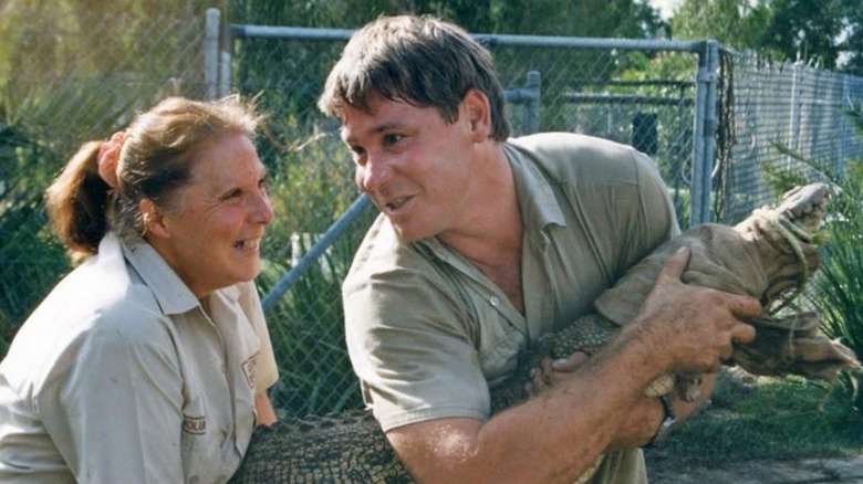 Steve Irwin holds alligator next to his mother