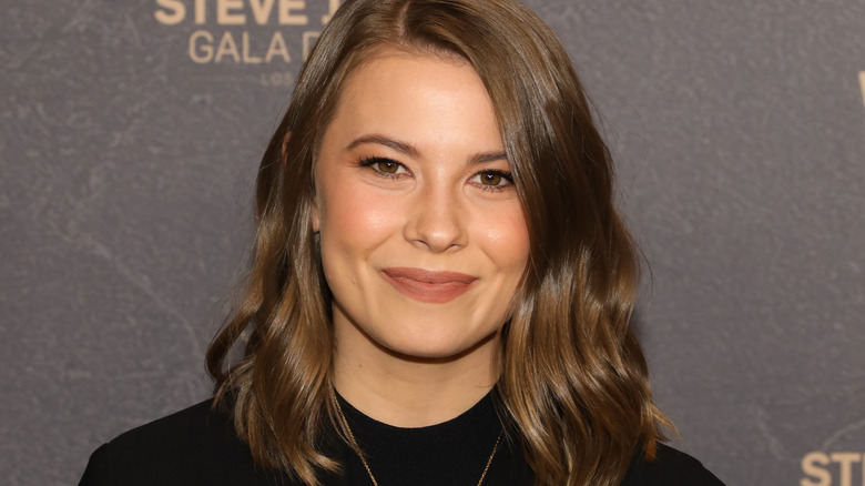 Bindi Irwin poses in a black top
