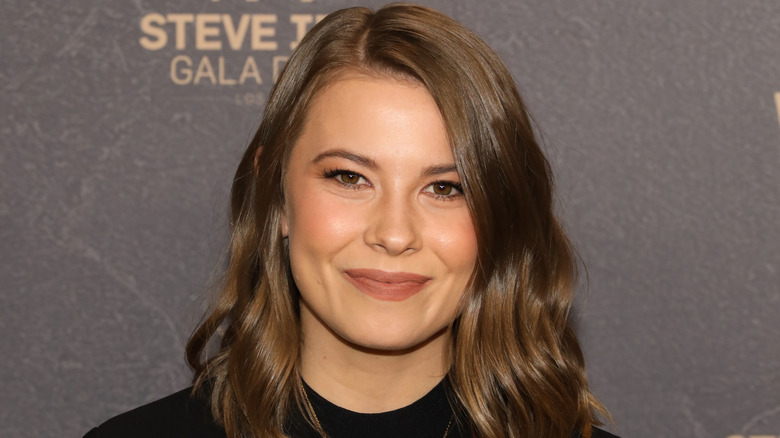 Bindi Irwin poses in a black top