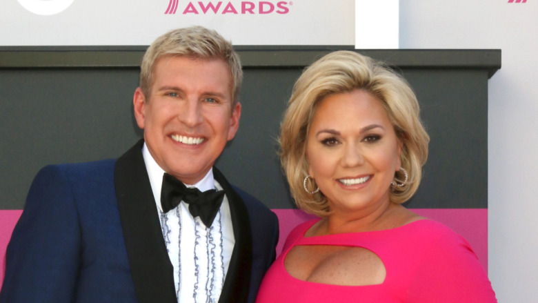 Todd Chrisley and Julie Chrisley smiling on red carpet 