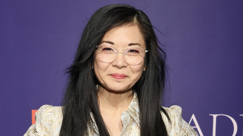 Keiko Agena posing in front of a purple background