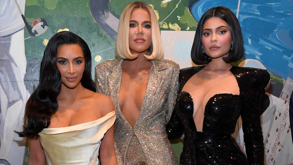 Kim Kardashian, Khloe Kardashian, and Kylie Jenner posing arm in arm together