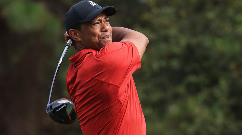 Tiger Woods playing a shot with a big swing