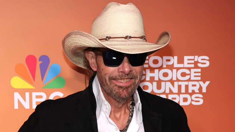 Toby Keith smiling in brown cowboy hat