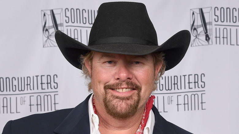 Toby Keith smiling with black cowboy hat