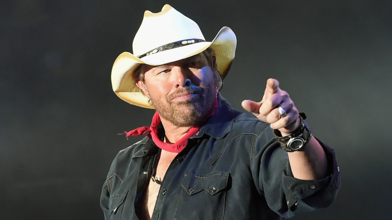 Toby Keith pointing in a white cowboy hat