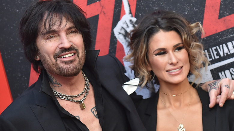 Tommy Lee and Brittany Furlan smiling on red carpet